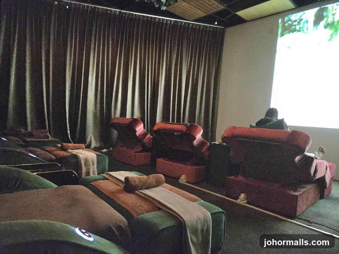 Relaxation room with reclining chairs and a projector screen