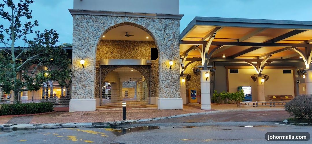 Outdoor walkway with stone archway and covered seating area