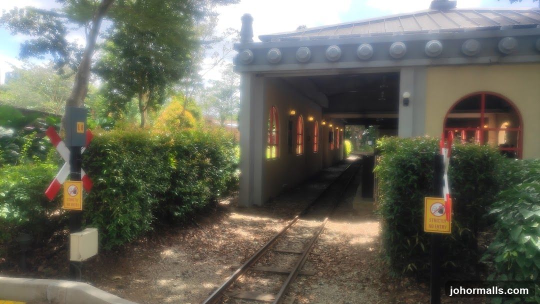 Train tracks leading to a covered structure