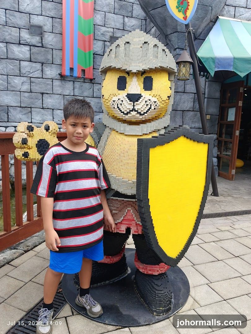 Boy Poses With Lego Knight Sculpture