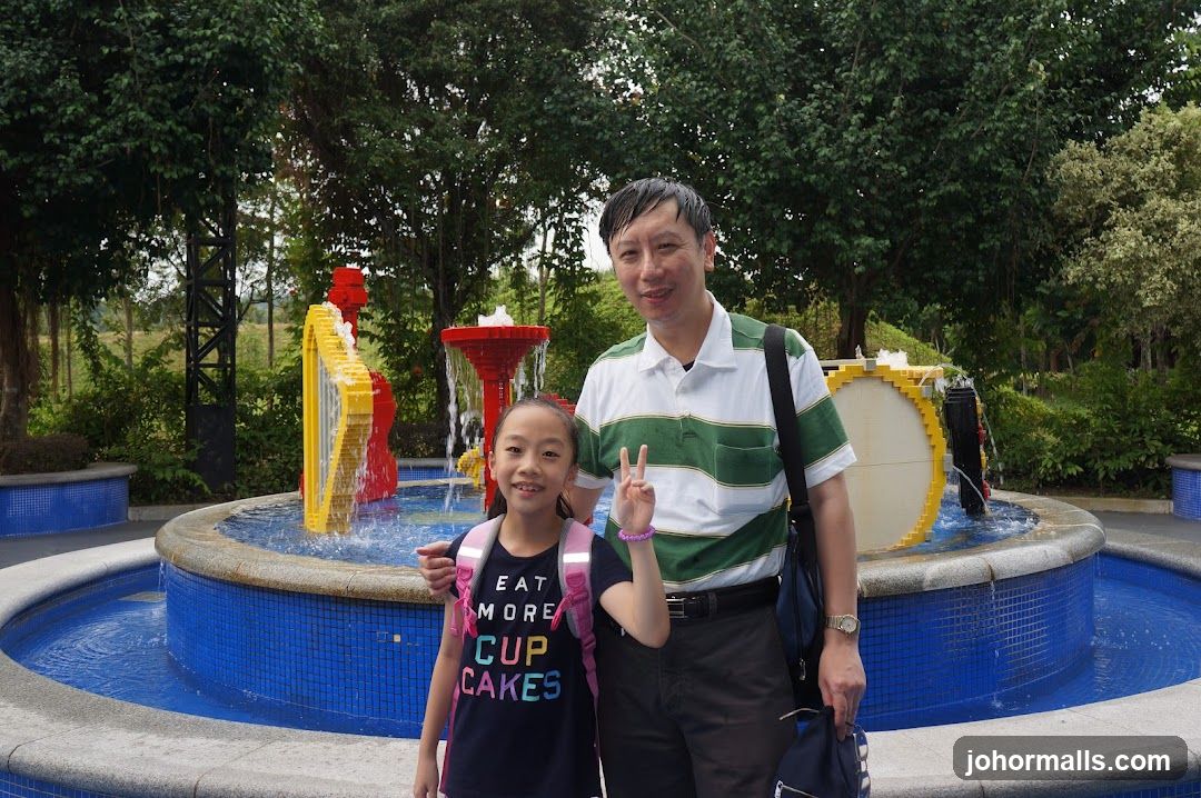 Father and Daughter by a Fountain