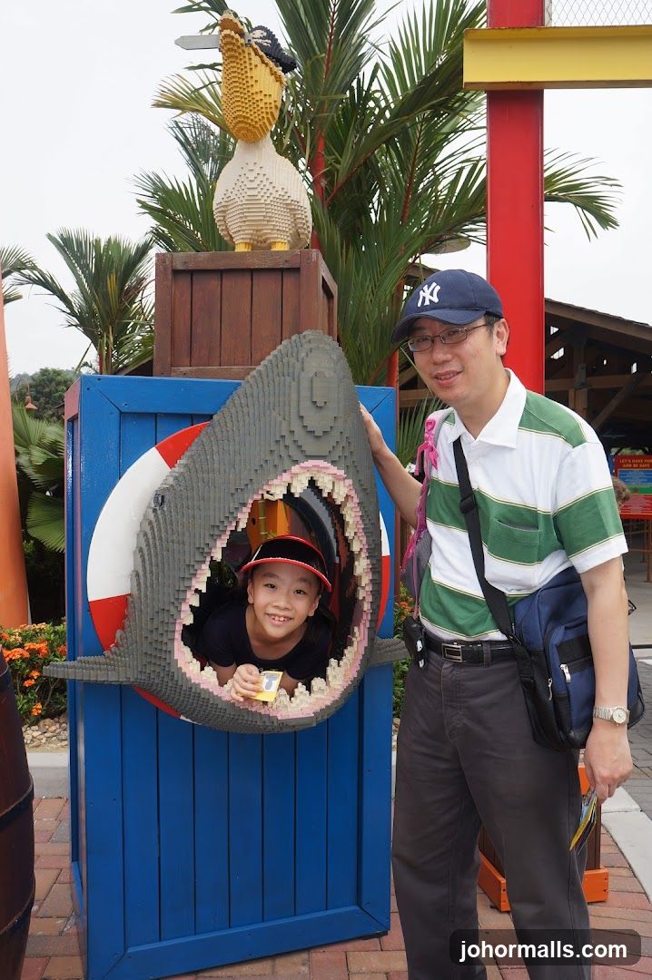Man and Child Posing with Lego Shark