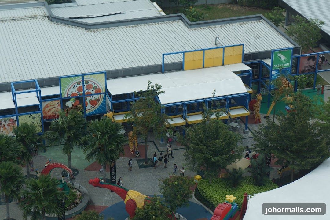 Outdoor dining area with pizza-themed decor and play structures