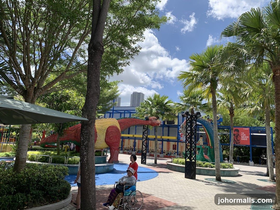 Outdoor park with dinosaur and palm trees