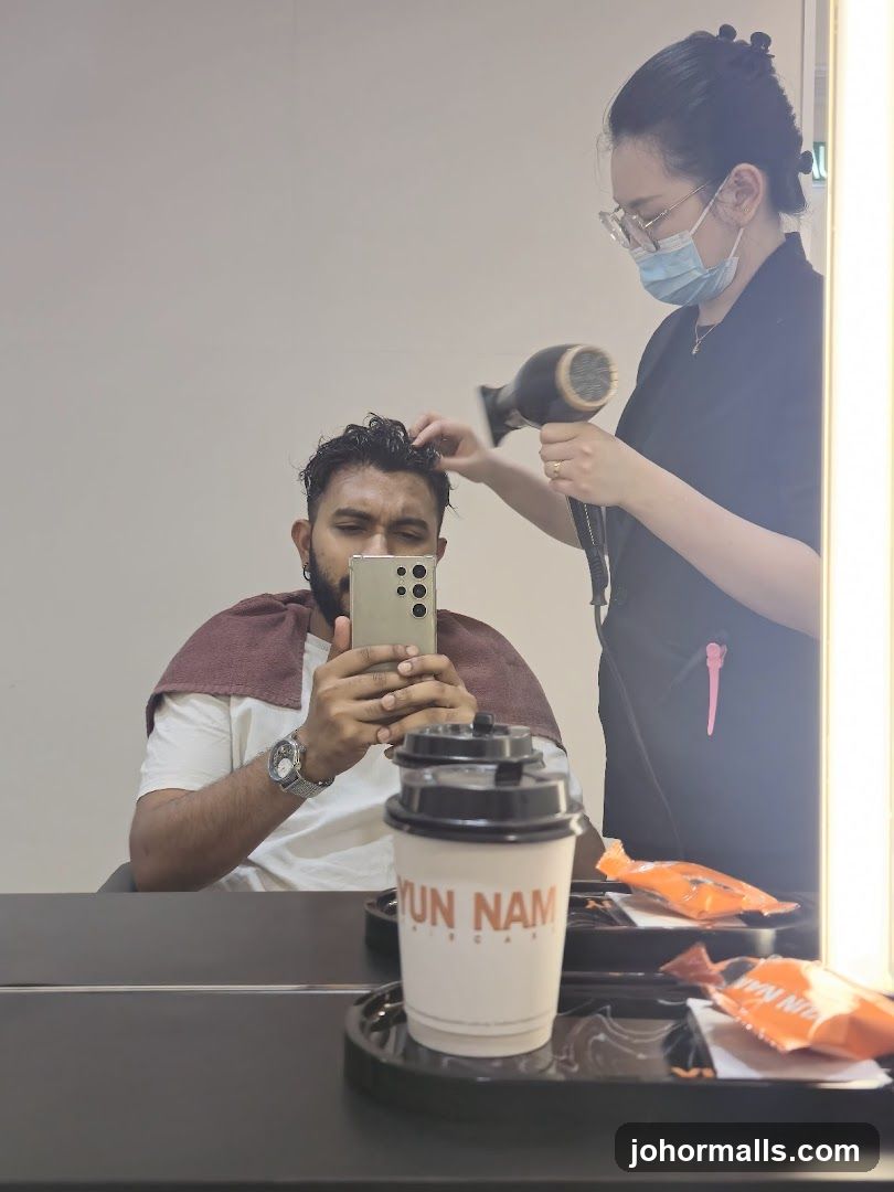Hairdresser drying client's hair
