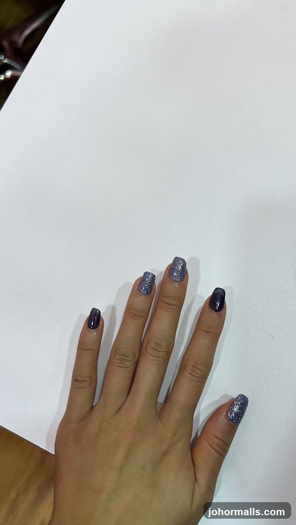 Hand with Glitter and Dark Purple Nails