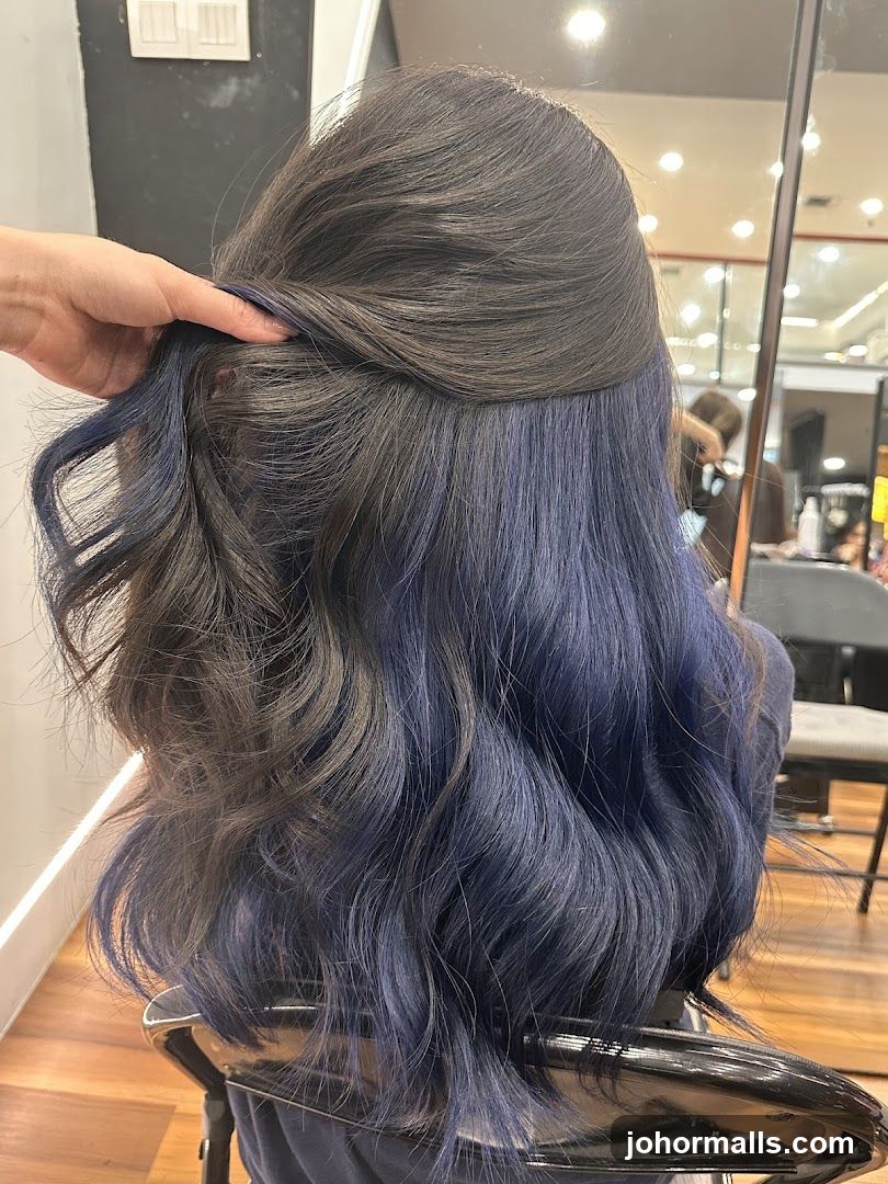 Woman with dark hair with blue highlights