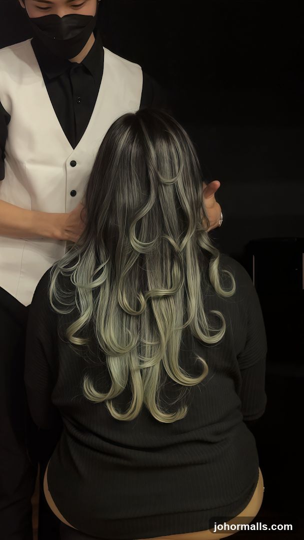 Hairdresser styling client's hair