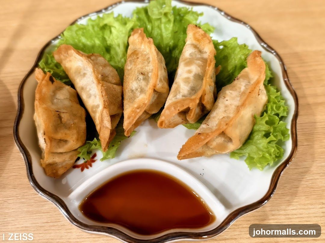 Pan-fried dumplings with dipping sauce