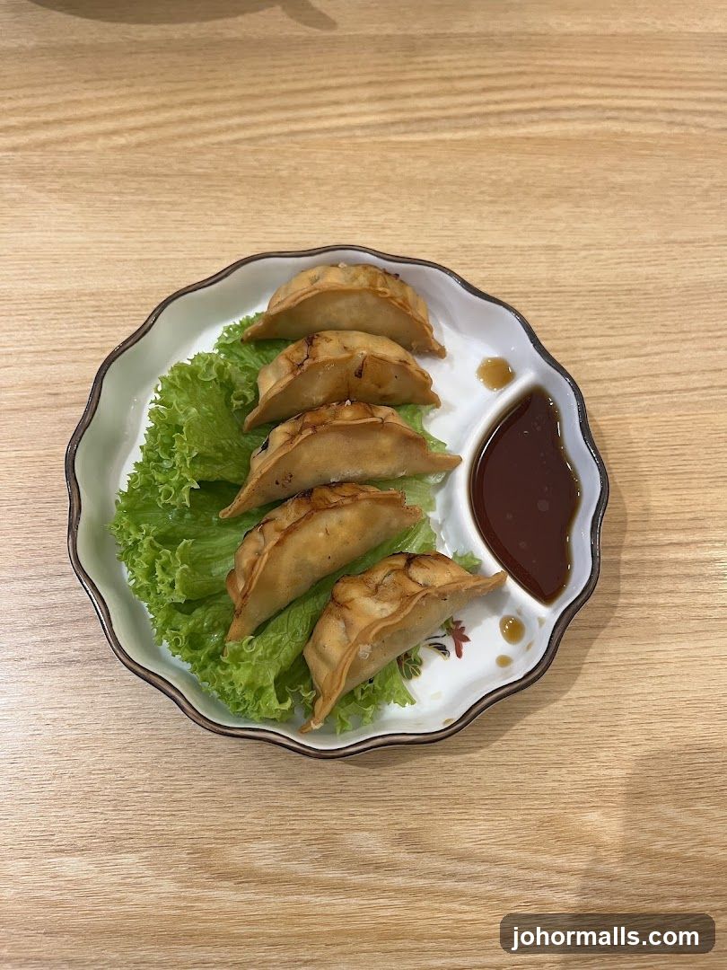 Pan-fried dumplings with dipping sauce