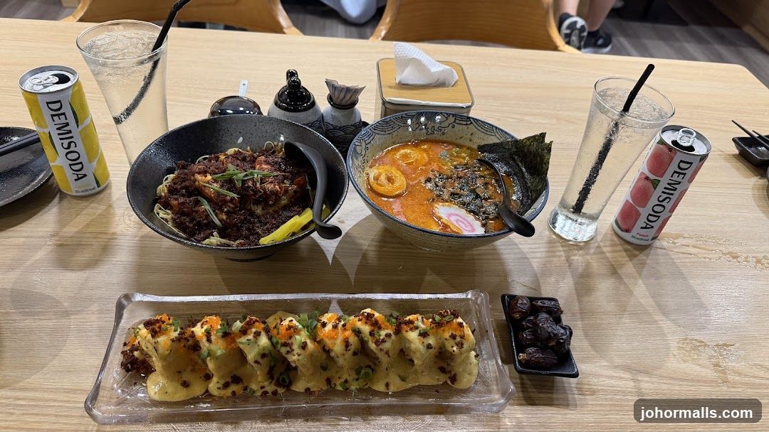 Table with Ramen, Sushi Rolls, and Drinks