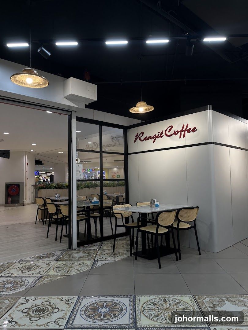 The exterior of a coffee shop with a sign that reads "Rengit Coffee". The shop has a modern design with white walls and black accents. Inside, there are tables and chairs for customers. The floor is decorated with patterned tiles.