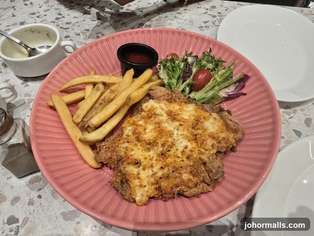 Chicken dish with fries and salad