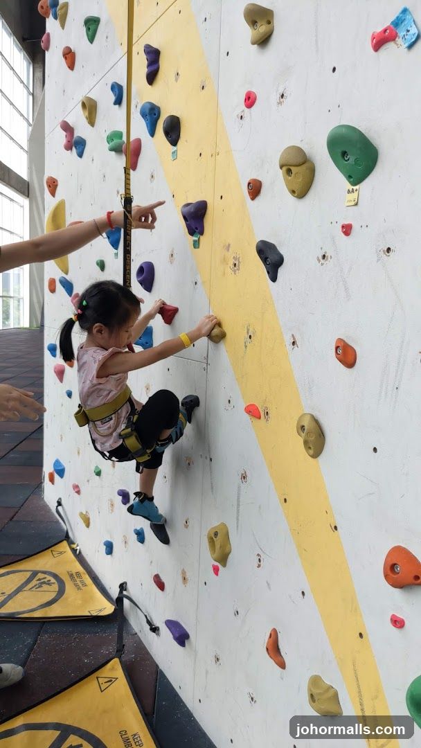 Child climbing a rock wall
