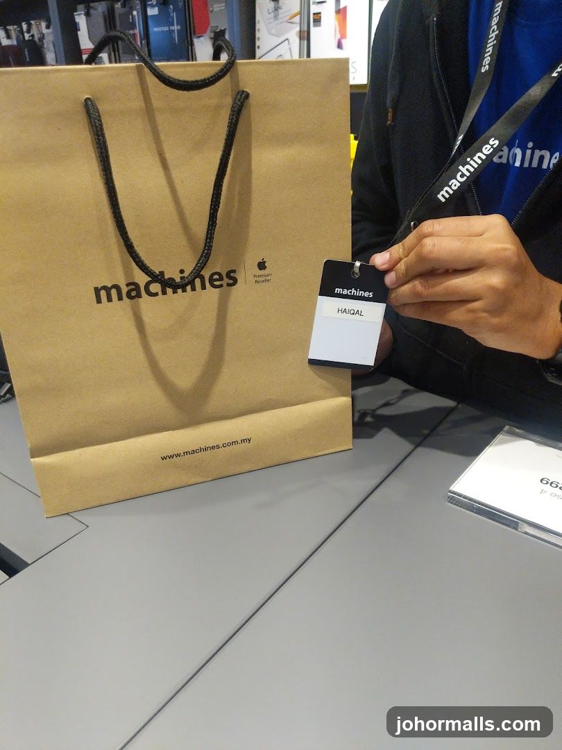 Brown paper shopping bag with Apple logo and "machines" branding