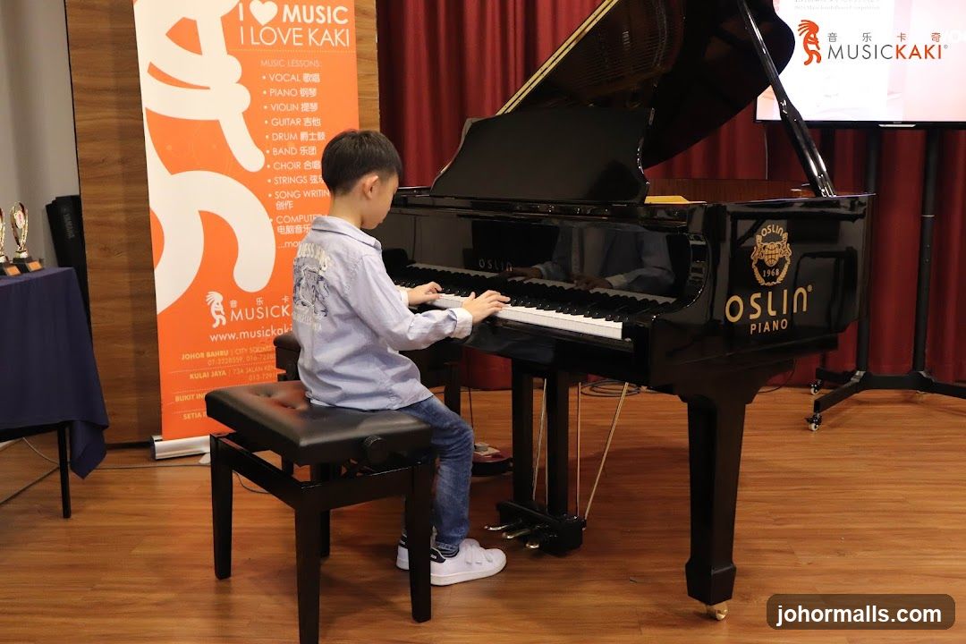 Child playing piano in music studio