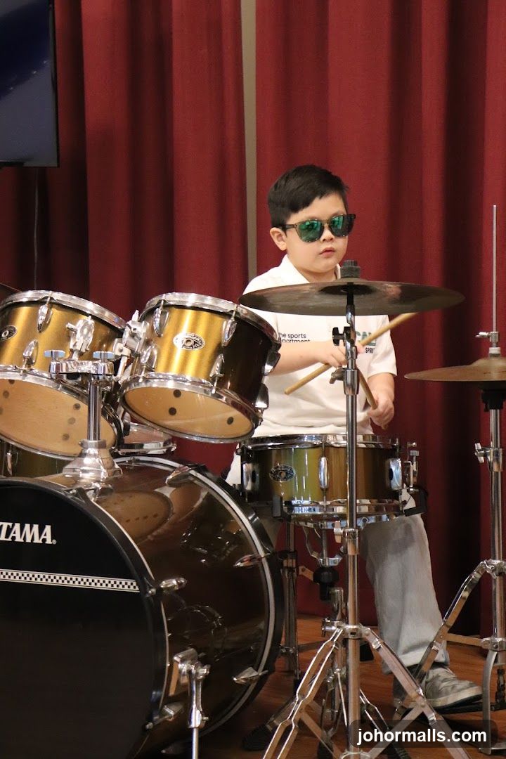 Child playing drums in performance setting