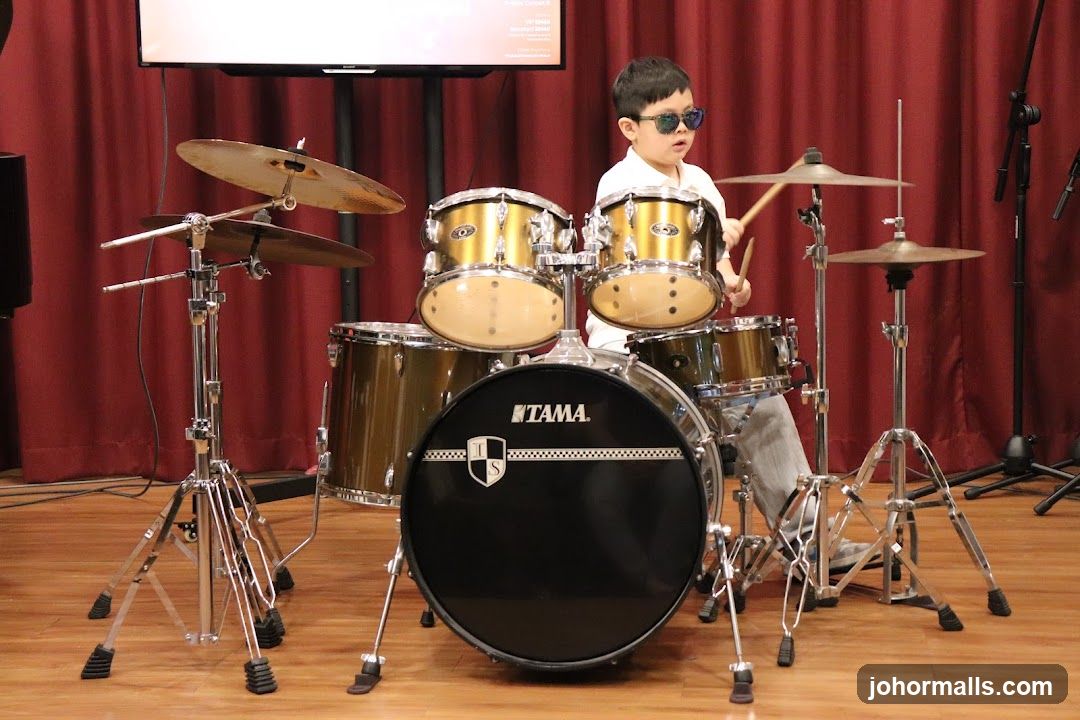Child playing drums in studio