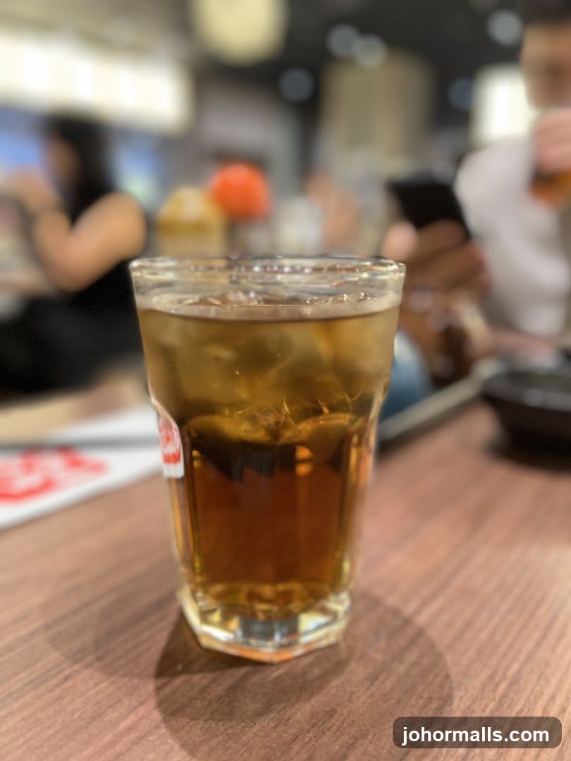 Glass of iced beverage on wooden table