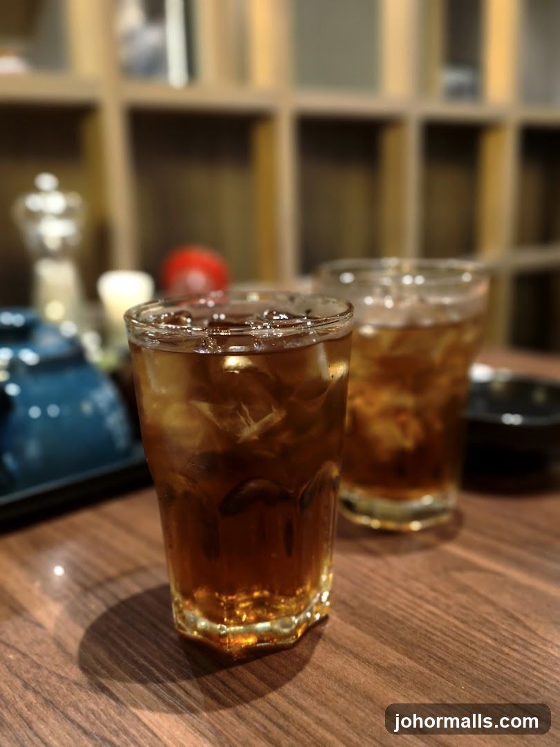 Two glasses of iced beverage on wooden table