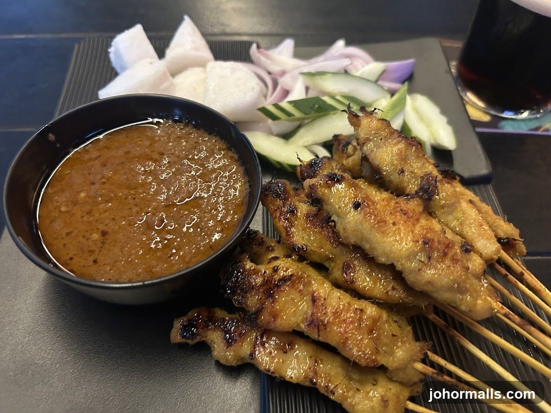 Satay with dipping sauce and accompaniments