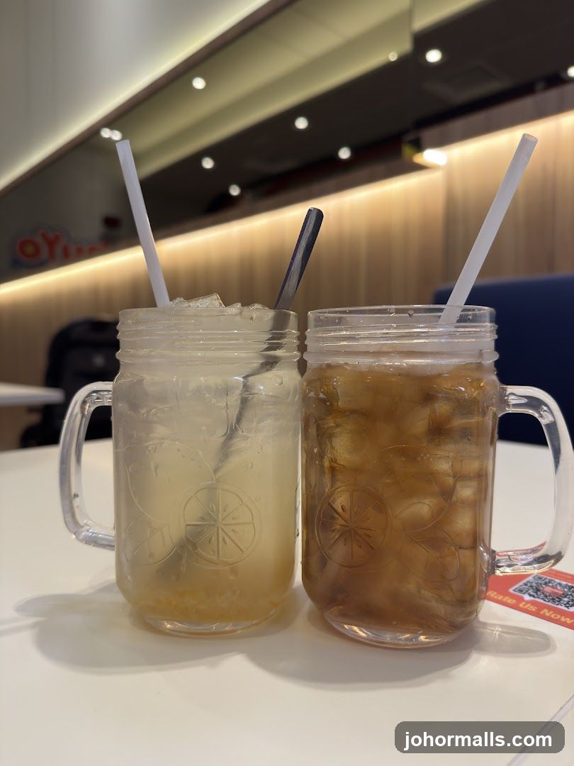 Two iced beverages in mason jars on a table