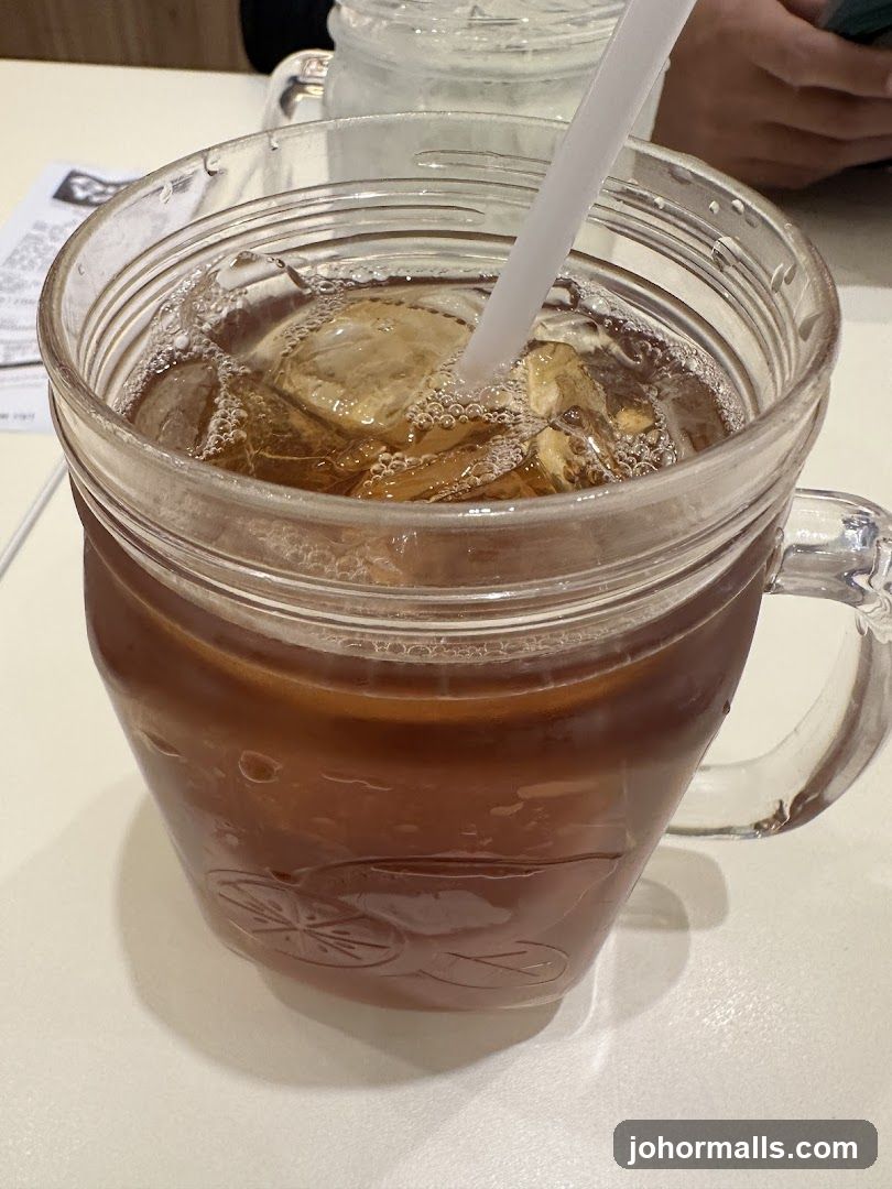 Iced beverage in mason jar with straw