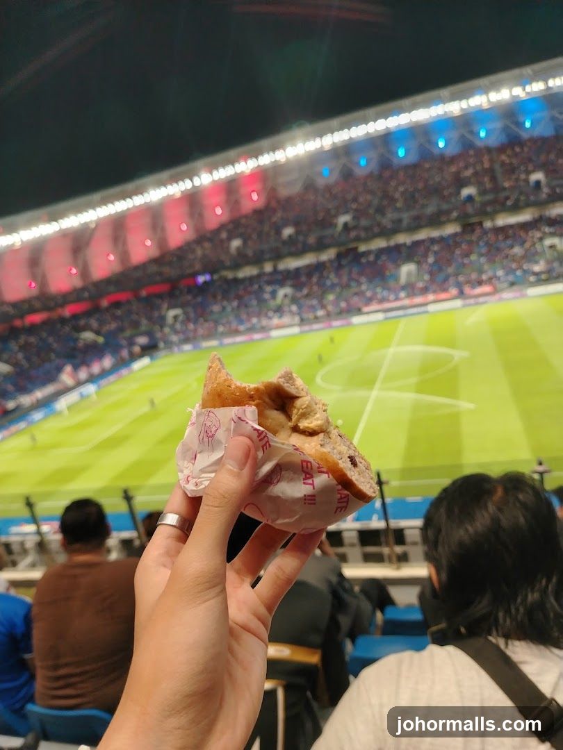 Hand holding food at stadium