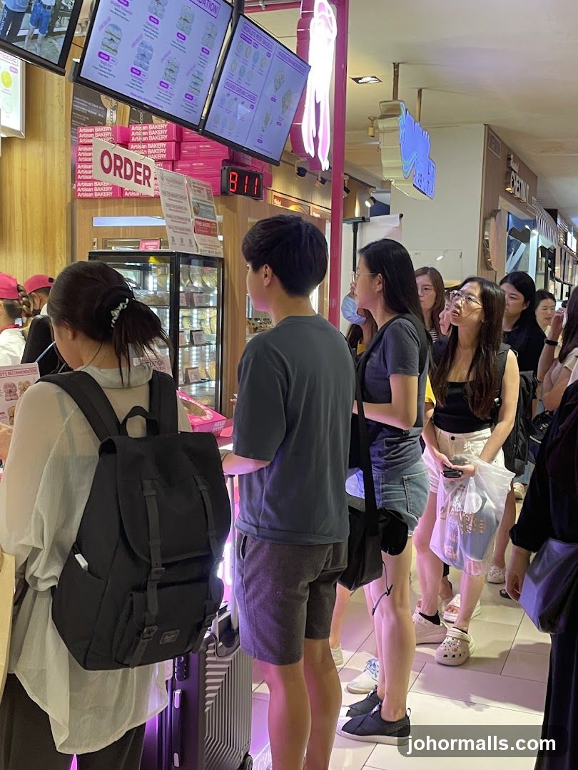 Customers waiting in line at a bakery counter