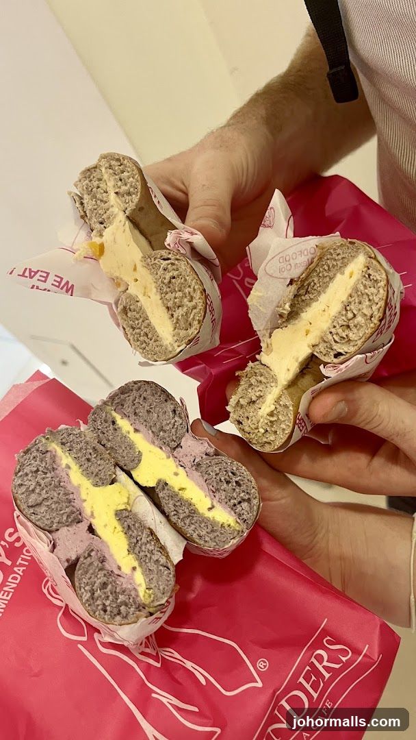 Bagel sandwiches held in hands