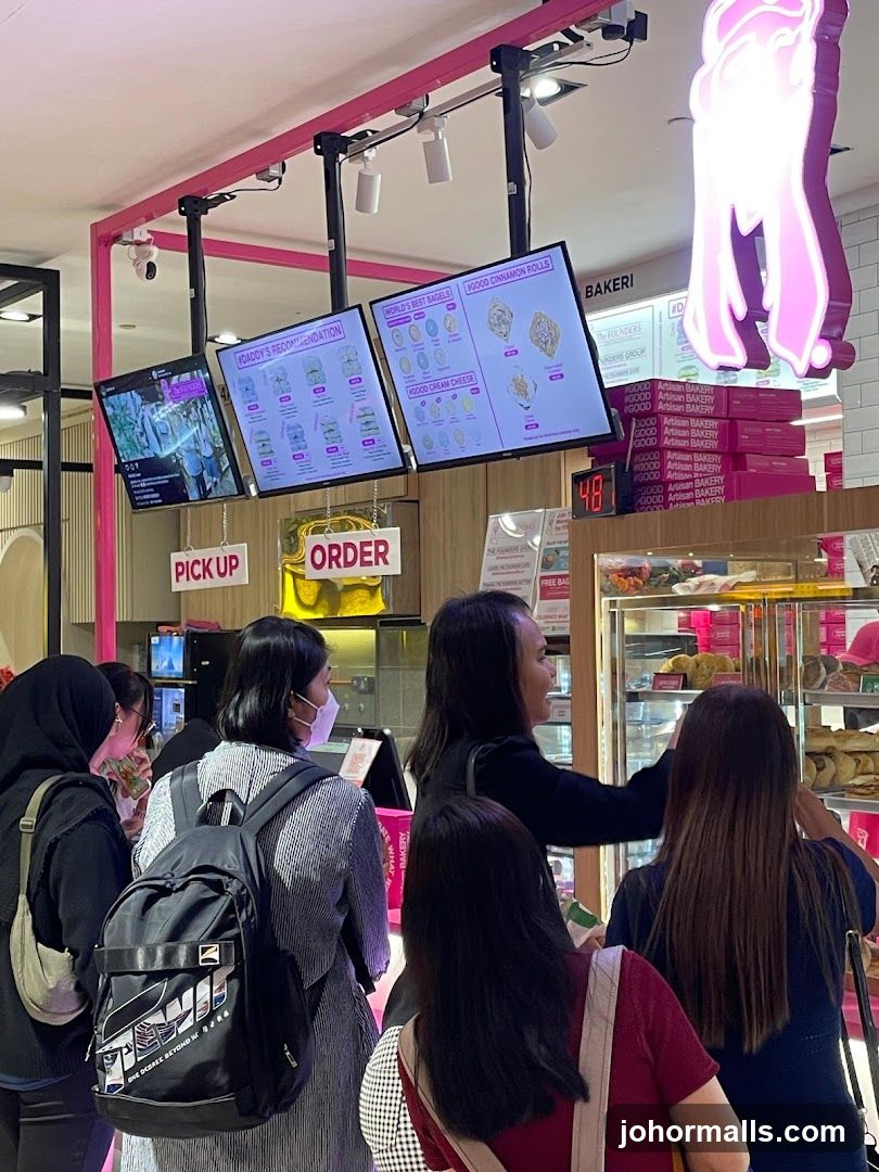 Bakery interior with customers and digital displays