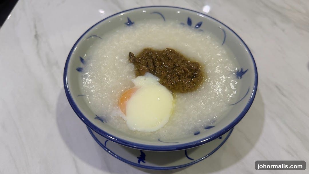 Bowl of congee with egg and meat topping