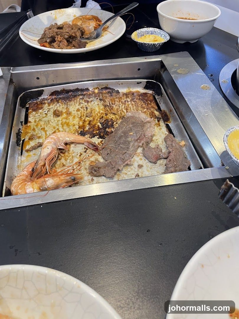 Grilled meat and seafood on a hot plate