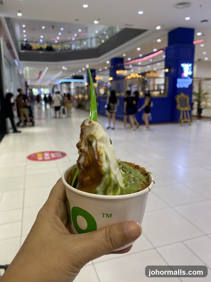 Hand holding dessert in shopping mall