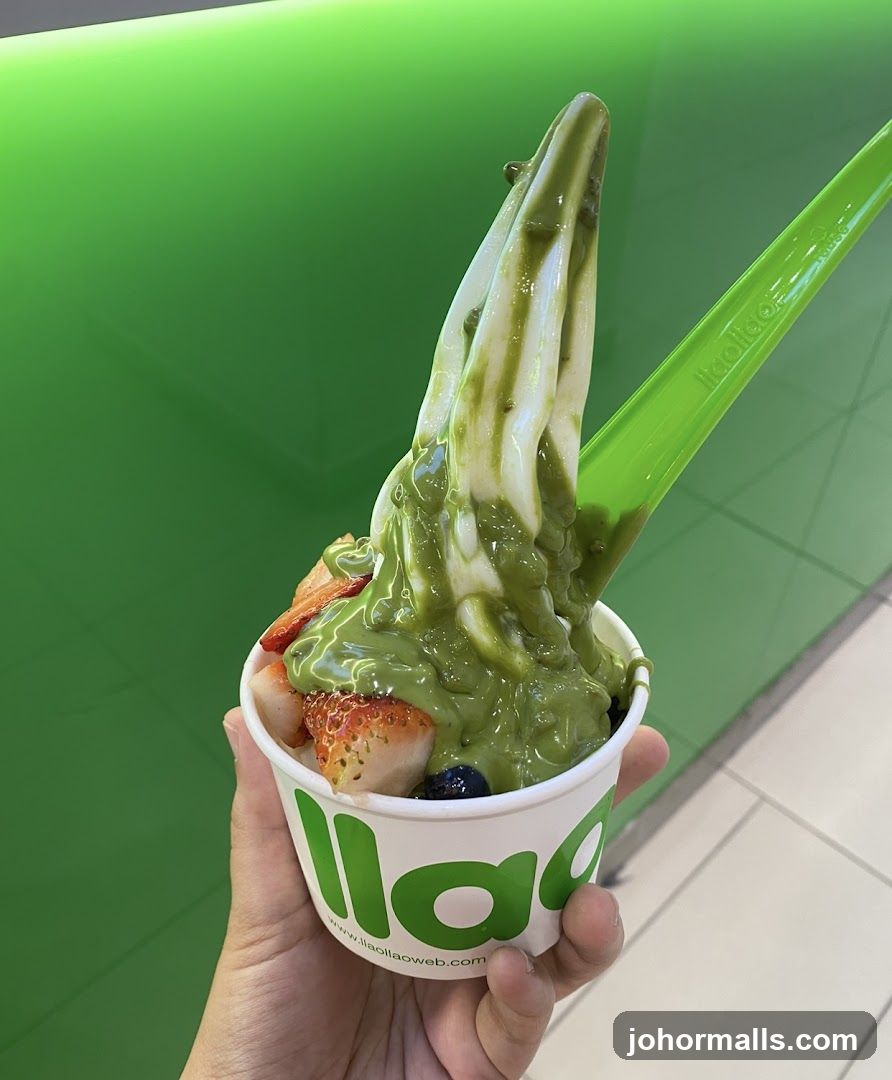Hand holding frozen yogurt cup