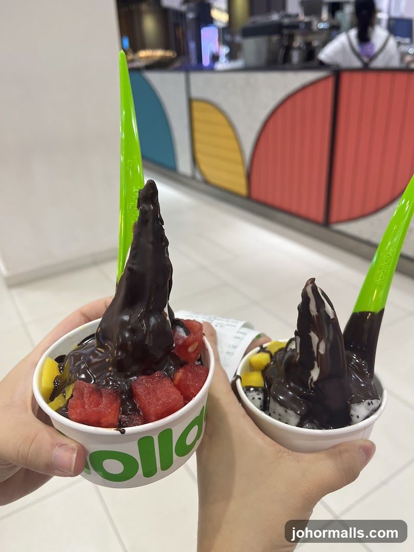 Two hands holding frozen yogurt cups