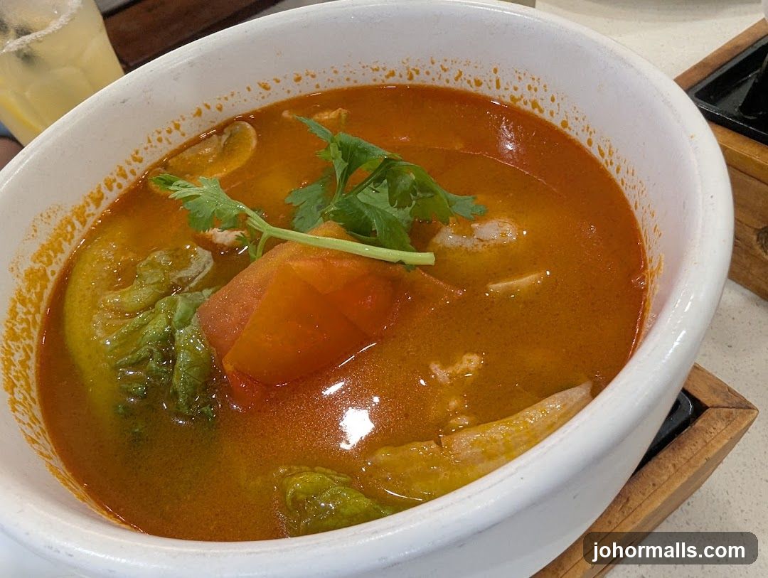 Tomato-based soup in white bowl