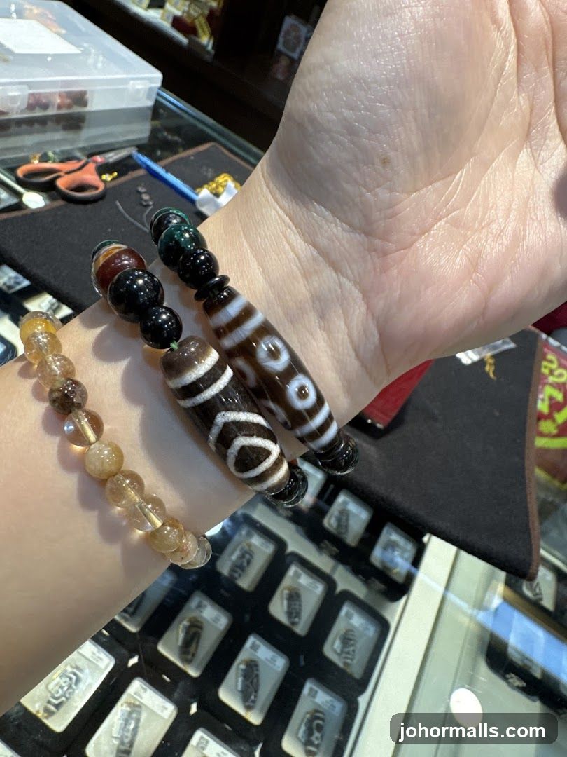 Hand wearing beaded bracelets