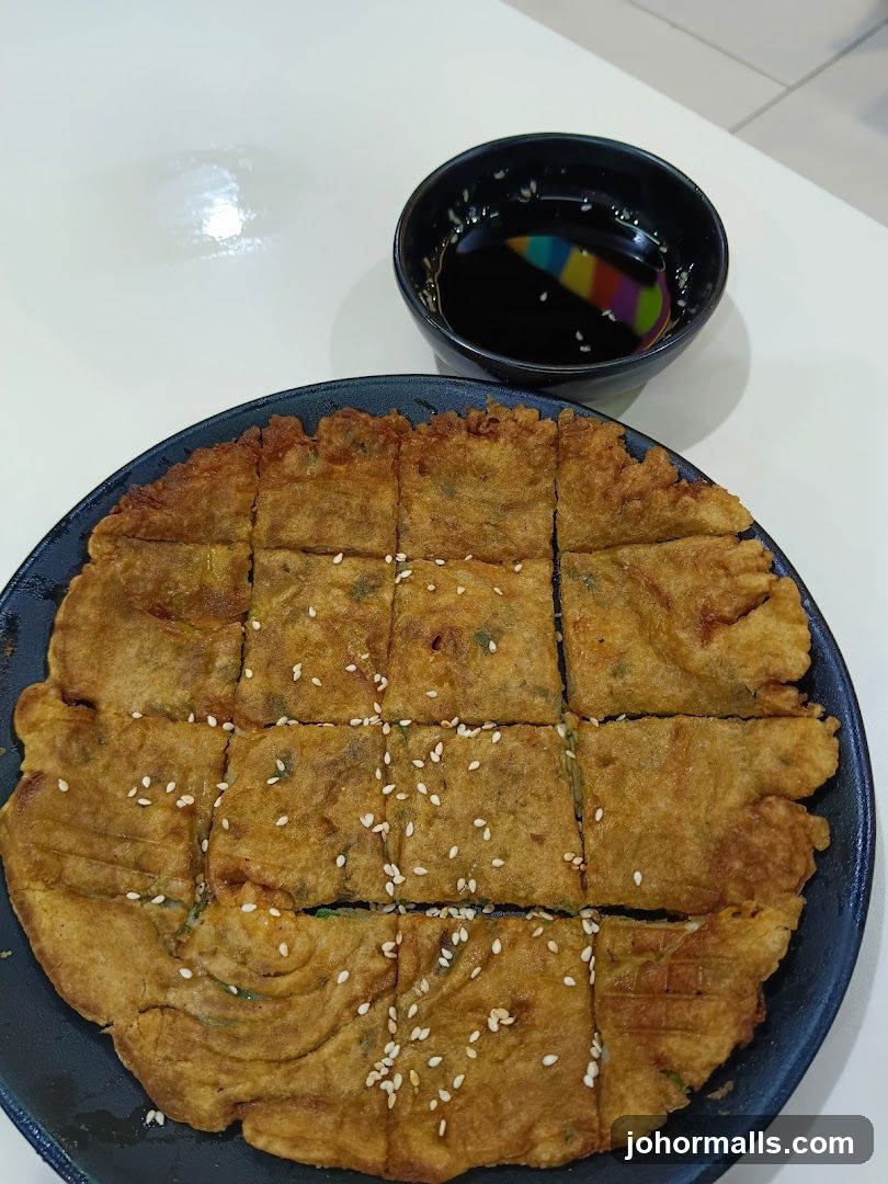 Food Item on Plate with Sauce Bowl