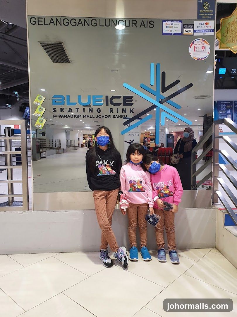 Children posing in front of BlueIce Skating Rink entrance