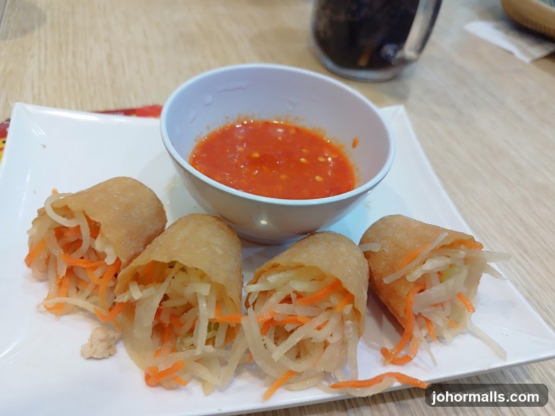 Food Plate with Spring Rolls and Sauce