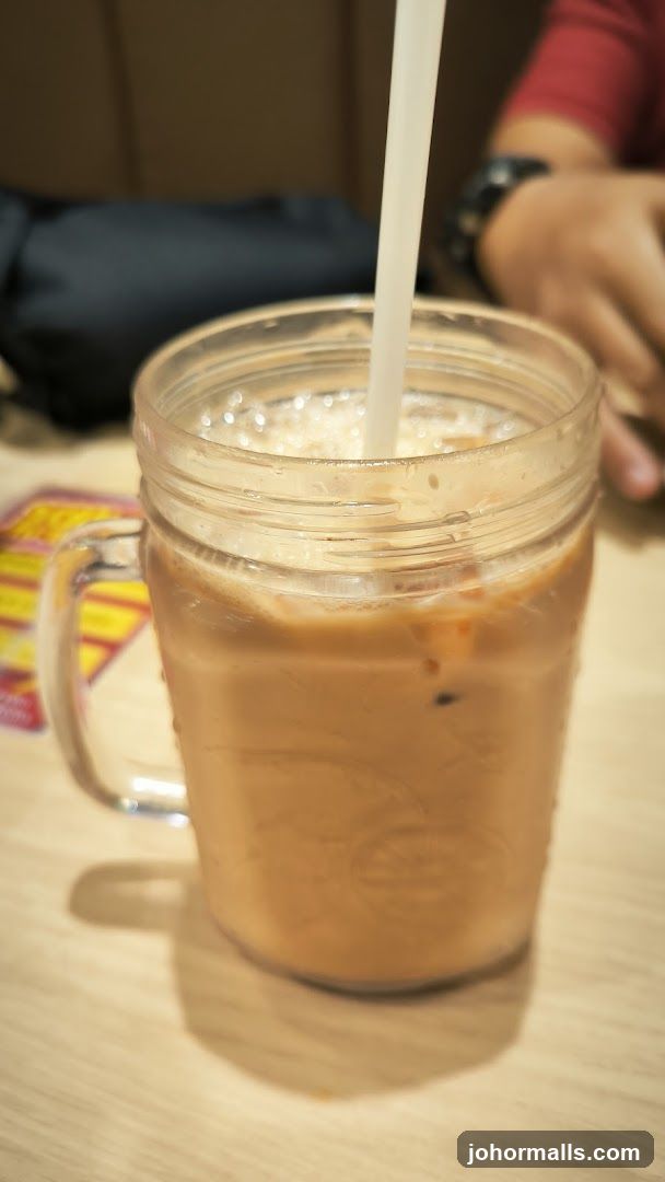 Iced beverage in mason jar with straw