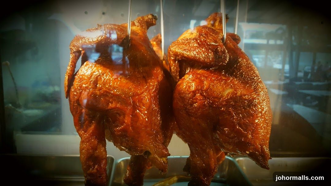 Roasted chickens in display case