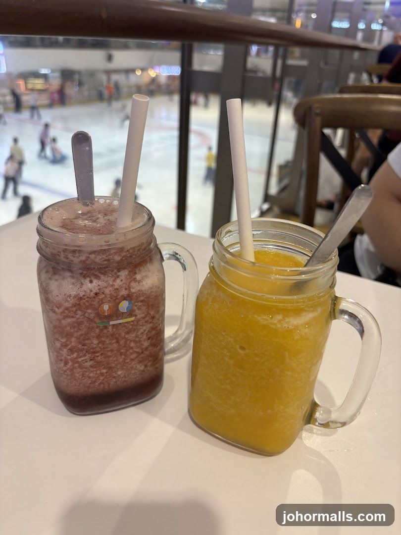 Two beverages on a table with ice rink view