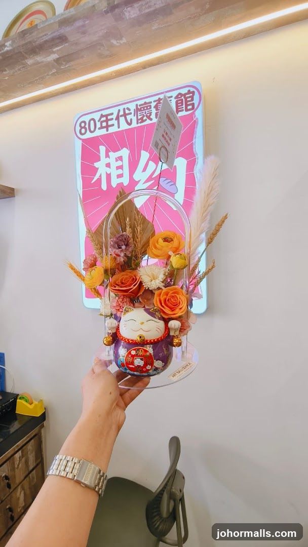 Hand holding decorative item in front of wall poster