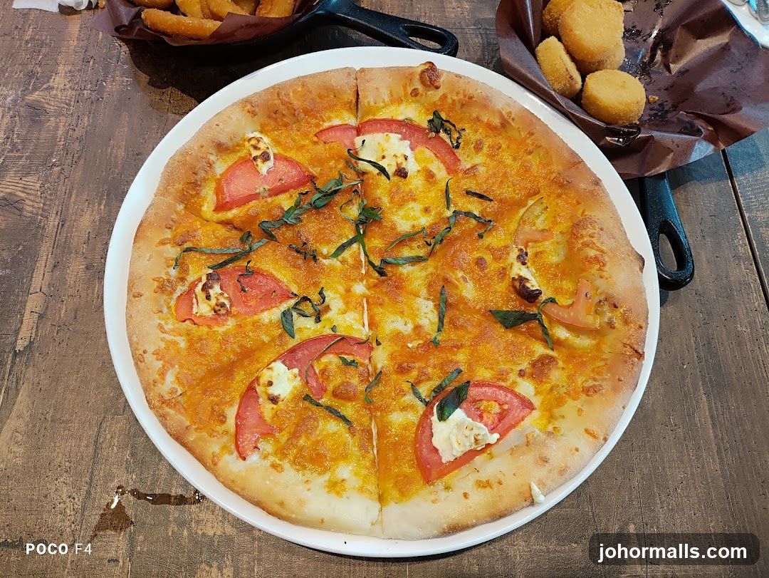 Pizza and side dishes on wooden table