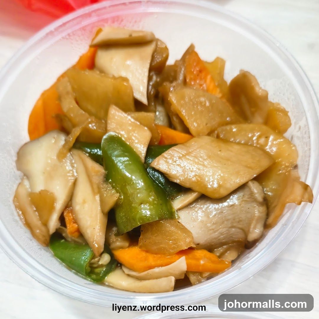 Stir-fried vegetables and mushrooms in a plastic container