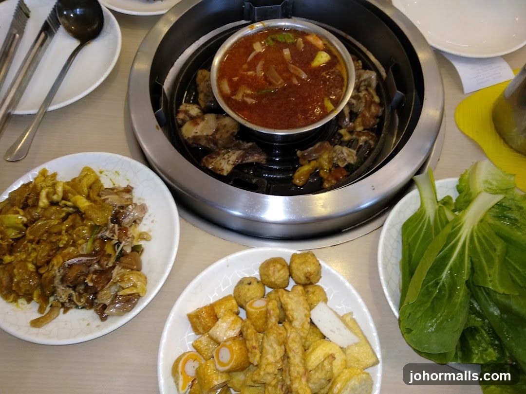 Table with hot pot and side dishes