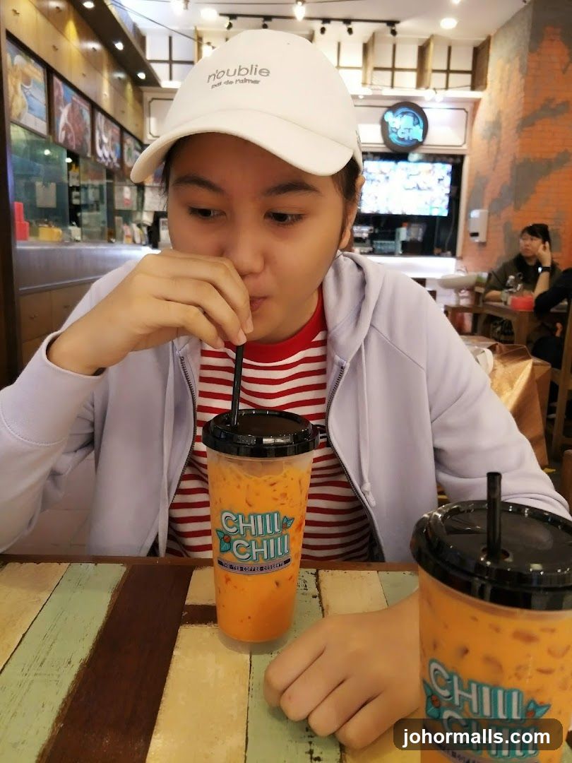 Person drinking beverage at counter