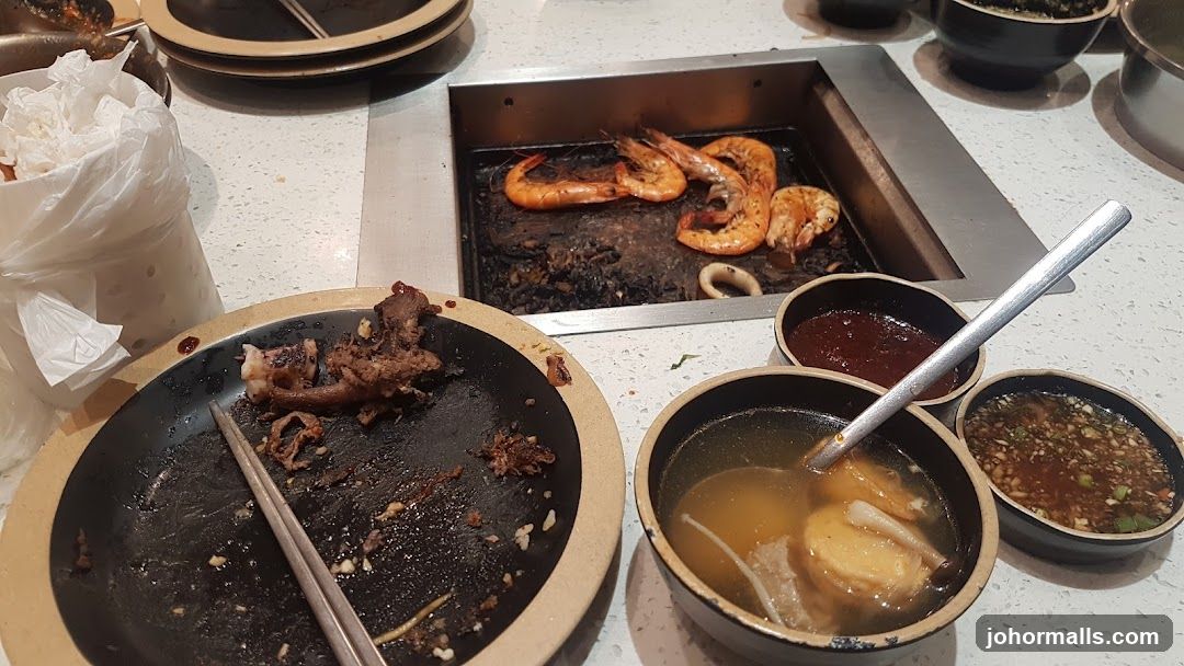 Table with Leftover Food and Grill